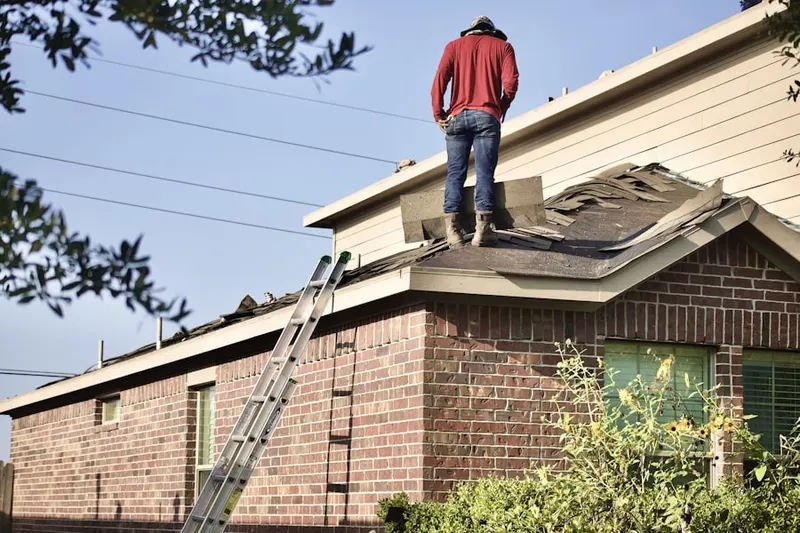 Professional roofer working on a residential roof in Winters Run